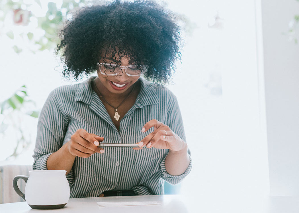 woman with glasses taking a photo of her check